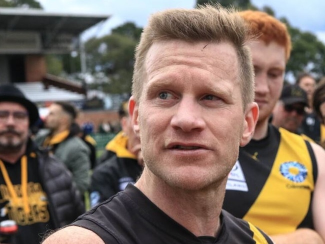 Mitcham coach Neil Winterton in the huddle. Picture: Davis Harrigan