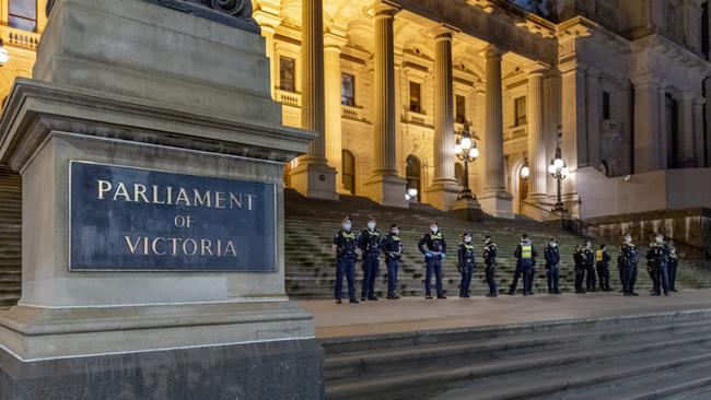 Victoria Police officers patrol Melbourne’s CBD on Monday before a new curfew and Covid restrictions come into place. Picture: David Geraghty