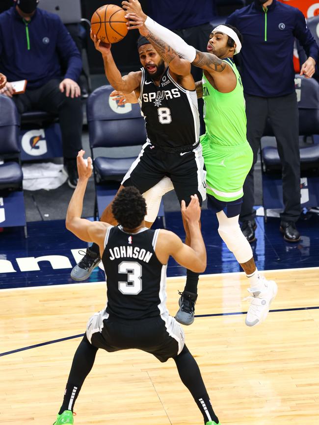 Australian and Spurs star guard Patty Mills steals a pass intended for Minnesota’s D’Angelo Russell during his team’s 96-88 loss to the Timberwolves on Sunday. Mills stood out with 18 points in that game. Picture: Harrison Barden/Getty Images/AFP