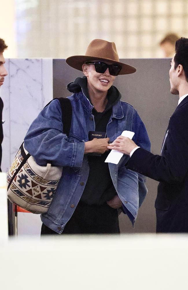 Theron was all smiles as she chatted to staff at Sydney Airport. Picture: MEDIA-MODE.COM