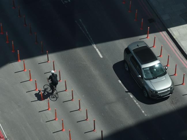 A cyclist travels along a temporary bicycle lane on Nine Elms lane in Wandsworth, south west London. Picture: AFP