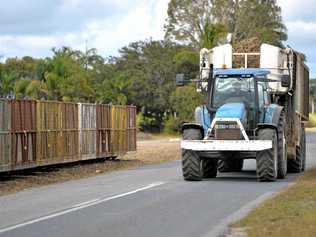 A tractor with a loaded bin about to pull up near bins to drop off it's load. Picture: Tony Martin