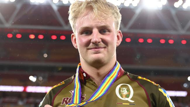 BRISBANE, AUSTRALIA - APRIL 25:  Tom Lynagh of the Reds hold the ANZAC medal after the round 11 Super Rugby Pacific match between Queensland Reds and Blues at Suncorp Stadium, on April 25, 2025, in Brisbane, Australia. (Photo by Chris Hyde/Getty Images)