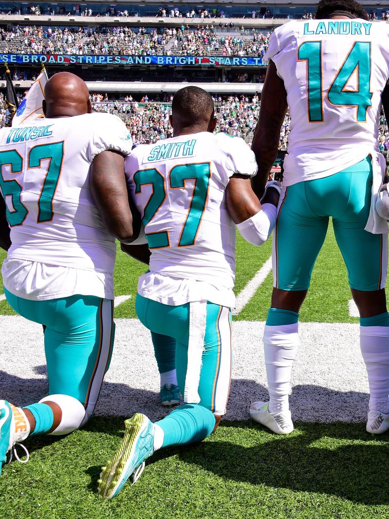 Miami Dolphins NFL players take the knee.