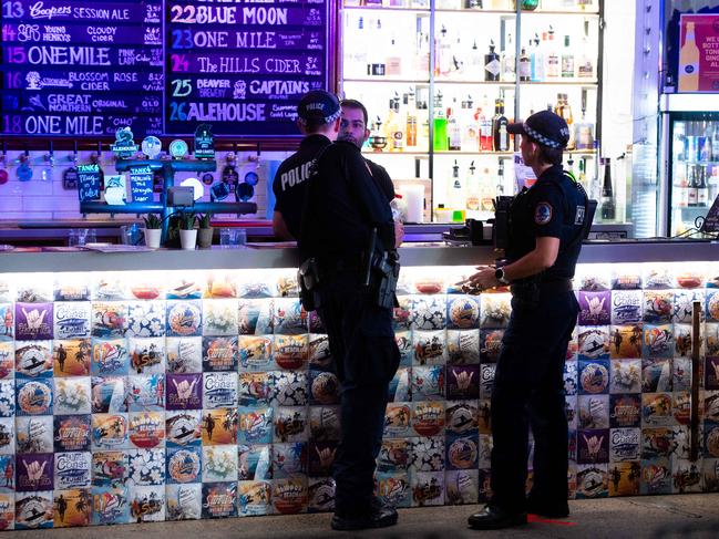 Senior Sergeant Lee Morgan and Senior Constable Megan Duncan attend 6 Tanks on Mitchell St as part of a visible presence during the first round of coronavirus restrictions being lifted. Picture: CHE CHORLEY