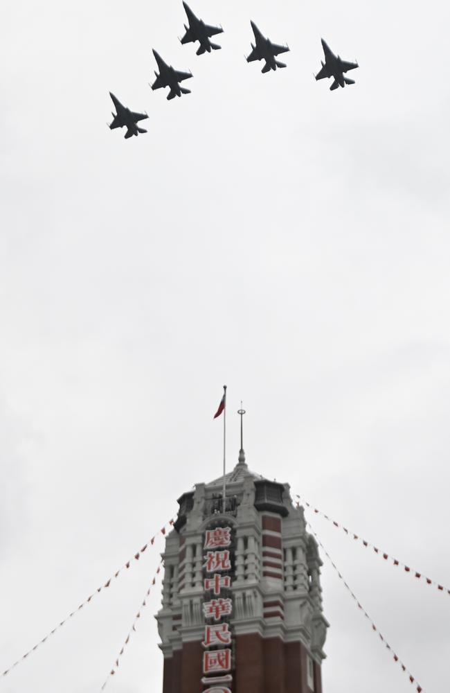 Five US-made F16 jets fly over the Presidential Office during Taiwan’s National Day in Taipei. Picture: Sam Yeh/AFP