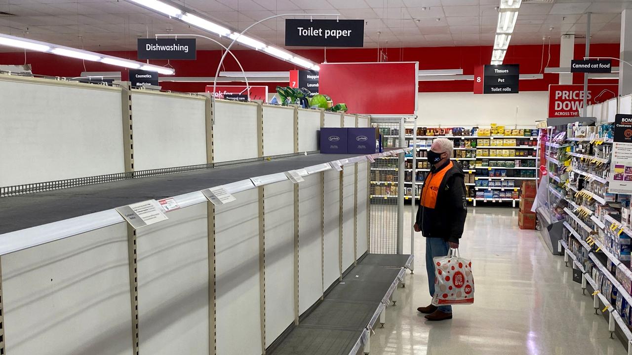 A shopper looks at the empty toilet paper shelves in a Melbourne supermarket this week, as the city's residents returned to lockdown. Photo: William West/AFP