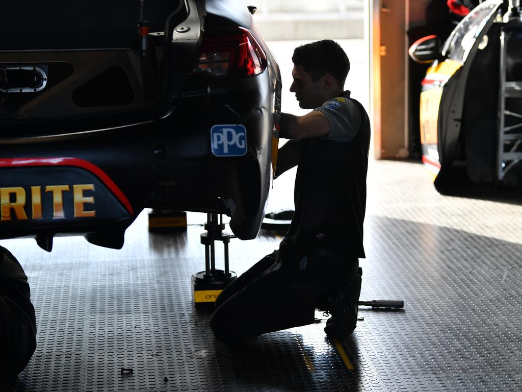 Crews work on cars before qualifying for Race 2 of the OTR SuperSprint at The Bend on Sunday. Picture: AAP Image/David Mariuz