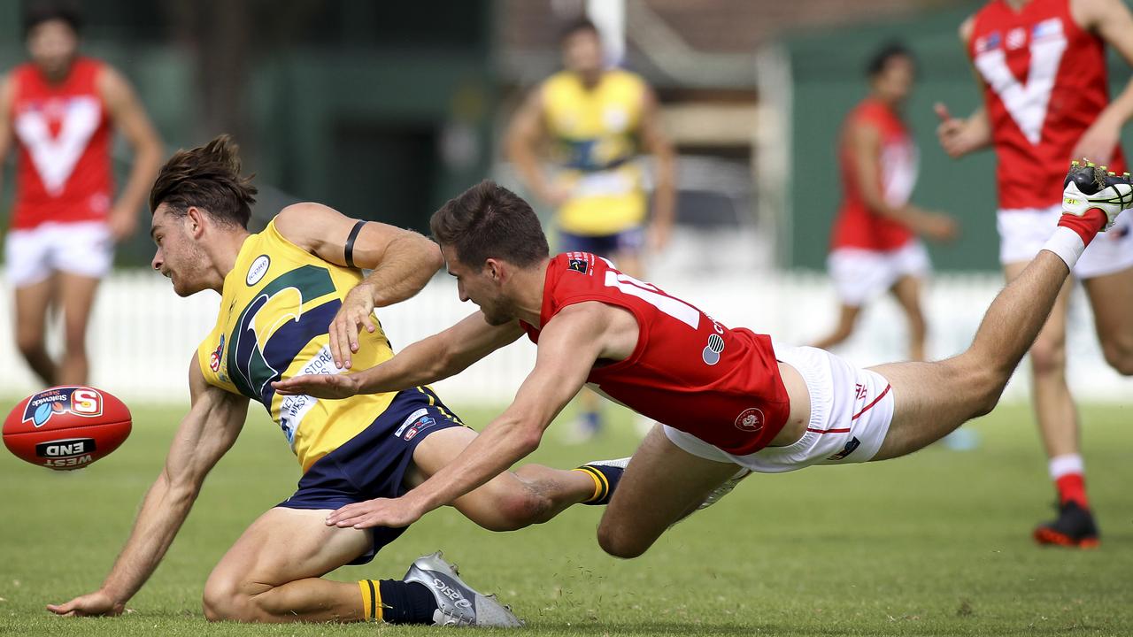 SANFL: Eagles v North Adelaide at Woodville Oval. North's Tom Schwarz dives for the ball with Eagle's Jordan Foote. 31 March 2019. (AAP Image/Dean Martin)