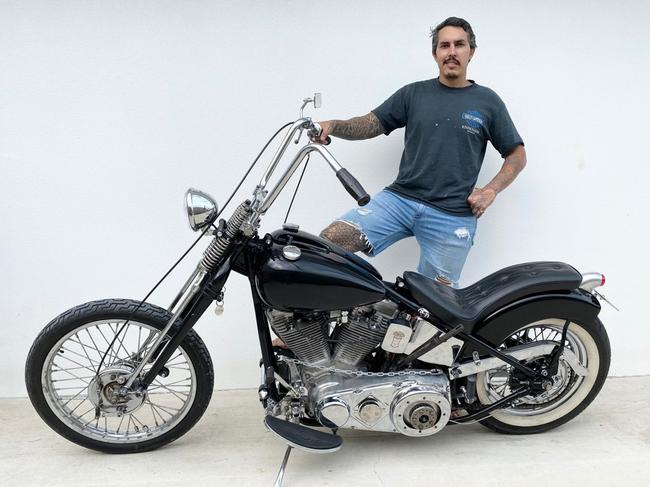 Townsville army veteran Adam Barrett shows off his rebuilt his Harley chopper.