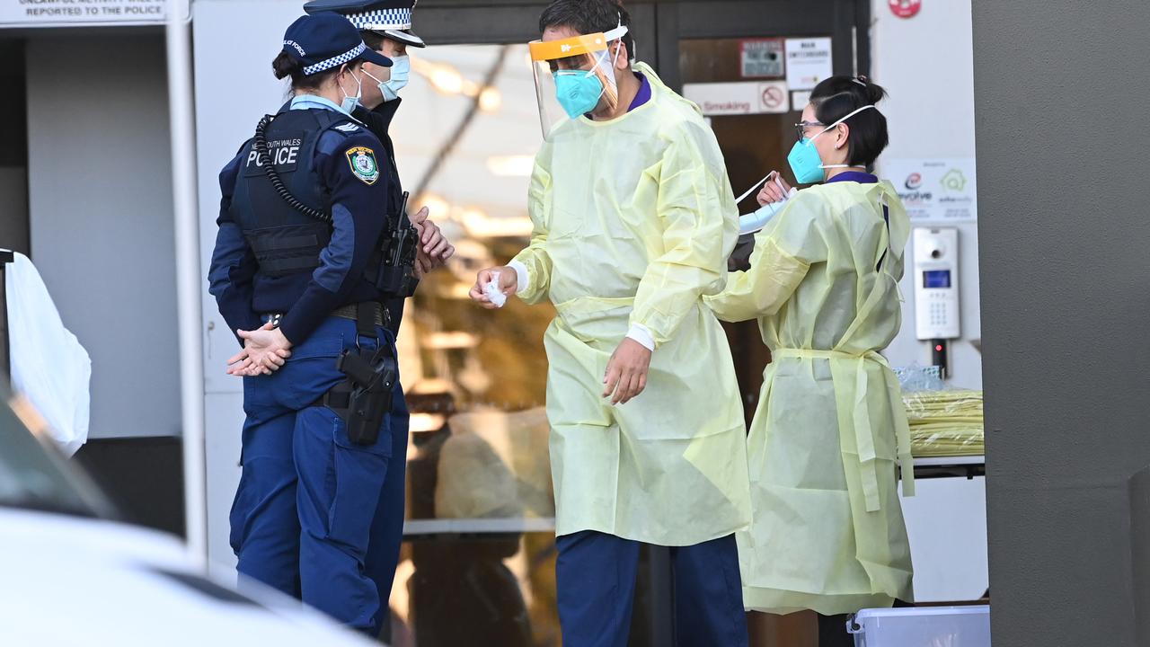 Nurses in full PPE outside the apartment block. Picture: NCA NewsWire/Jeremy Piper