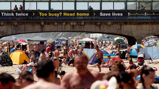 Sunbathers enjoy the sunny weather on Boscombe beach in Bournemouth, England. Picture: AFP