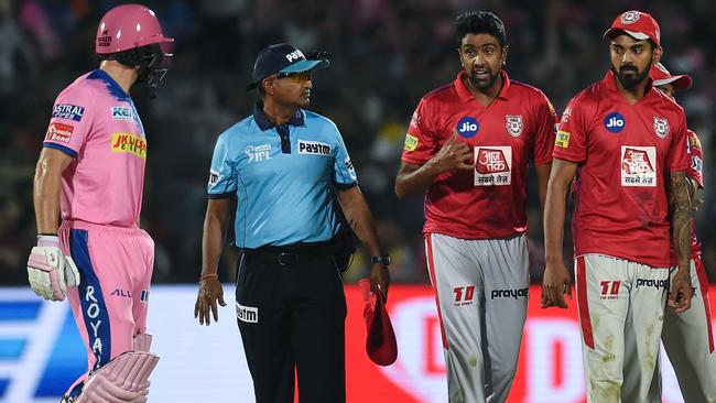 Rajasthan Royals' Jos Buttler (L) exchanges words with Kings XI Punjab's Ravichandran Ashwin (2nd R) after his 'Mankad' dismissal. Picture: Money Sharma/AFP