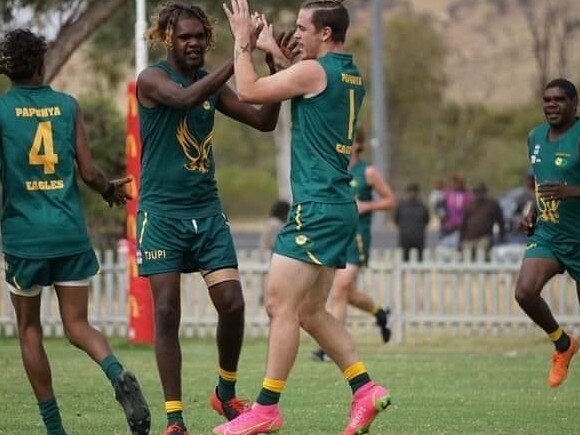 Braydon Wiley celebrates a goal with a Papunya teammate. Picture: Braydon Wiley.