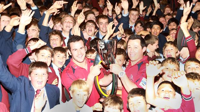 Former TSS star Jono Lance and high school coach Matt Taylor return to TSS with the Reds’ Super Rugby trophy. Pic Glenn Hampson