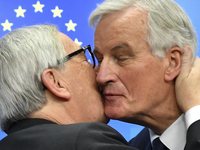 European Commission President Jean-Claude Juncker, left, kisses European Union chief Brexit negotiator Michel Barnier at the end of the EU summit in Brussels.