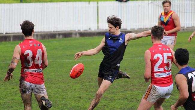 Henry Bennett gets a kick away for University Blacks in the VAFA. Picture: Facebook