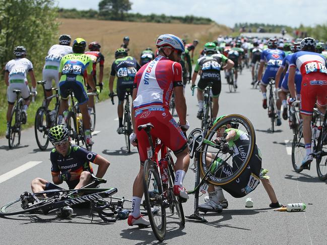 LE TOUQUET-PARIS-PLAGE, FRANCE - JULY 08: Jesus Herrada Lopez (L) of Spain and the Movistar Team and Bauke Mollema (R) of The Netherlands and the Belkin Pro Cycling Team pick themselves up off the road after being in a crash involving Chris Froome of Great Britain and Team Sky just after the start of stage four of the 2014 Le Tour de France from Le Touquet-Paris-Plage to Lille on July 8, 2014 in Le Touquet-Paris-Plage, France. (Photo by Doug Pensinger/Getty Images)