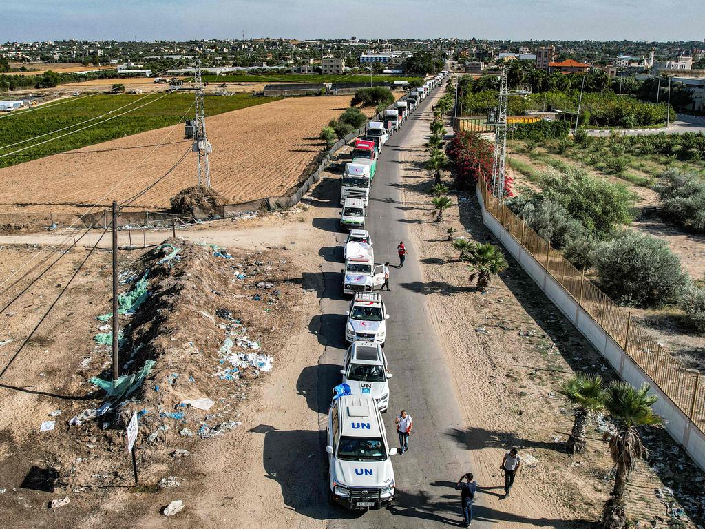 This aerial view shows some of the humanitarian aid trucks arriving from Egypt in the southern Gaza Strip on October 21. The four-day ceasefire will enable a rush of aid into Gaza for Palestinian civilians. Picture: Belal Al Sabbagh/AFP