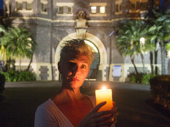 Trinette Reimer holds a candle outside the Grafton Jail one year after protests to stop the closure in town. Picture: Adam Hourigan