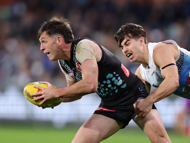 Zak Butters was well held by Oisin Mullin. Picture: Sarah Reed/AFL Photos via Getty Images
