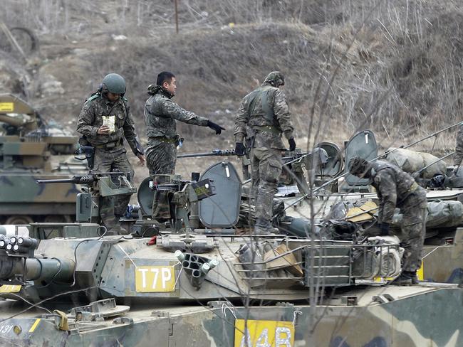 Military drill ... South Korean army soldiers work on K-1 tanks during the annual exercise in Paju, near the border with North Korea. Picture: AP Photo/Ahn Young-joon