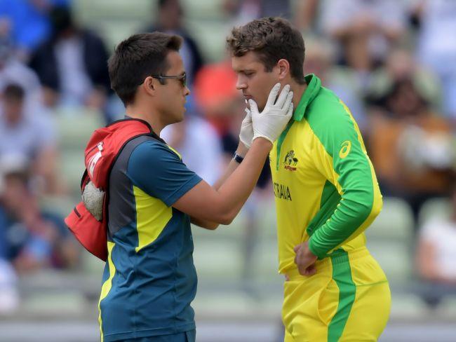 Alex Carey (R) is assisted by the team's medical staff. picture: AFP