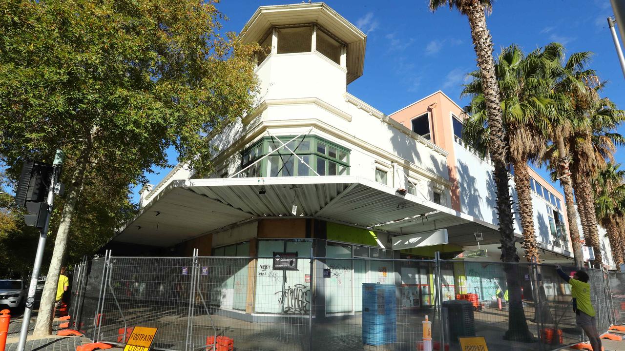 Workers fence off the Bright and Hitchcock building on the corner of Moorabool and Little Malop streets. Picture: Alison Wynd.