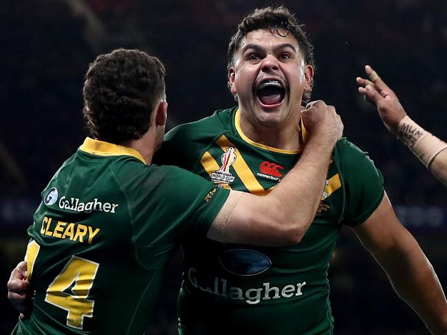 MANCHESTER, ENGLAND - NOVEMBER 19: Latrell Mitchell of Australia celebrates with teammates Nathan Cleary and Josh Addo-Carr after scoring their team's sixth try during the Rugby League World Cup Final match between Australia and Samoa at Old Trafford on November 19, 2022 in Manchester, England. (Photo by George Wood/Getty Images)