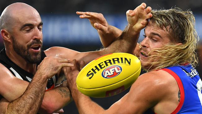 Steele Sidebottom and Smith wrestle for possession of the ball. Picture: Quinn Rooney/Getty Images