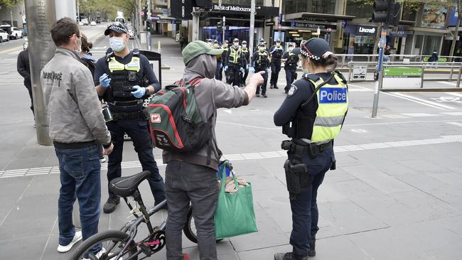 Police talk to people on Bourke Street Mall. Picture: Andrew Henshaw