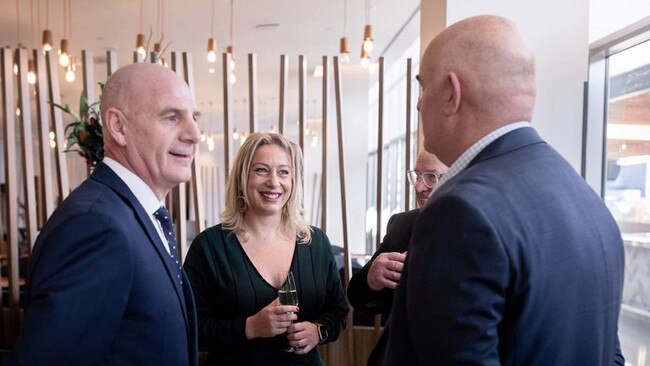 Rodger Powell, third from left partially obscured, shown at the opening of the Crowne Hotel in Hobart with Tasmanian Premier Peter Gutwein