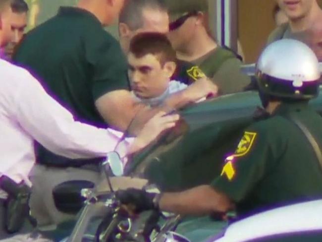 TV IMAGE FROM WPLG in FLORIDANikolas Cruz, the suspect in a shooting at Marjory Stoneman Douglas High School in Parkland, Fla., is escorted out of a hospital and into a police car.