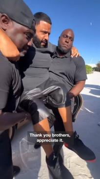 DJ Khaled is carried to keep shoes clean