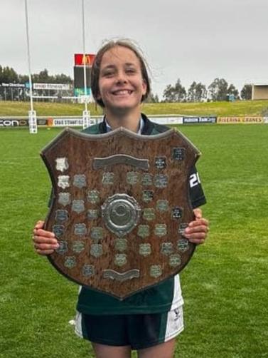 Sienna-Estelle Burraston proudly holds the NSW PSSA Open Rugby League shield after winning with Sydney South West. Picture: Contributed