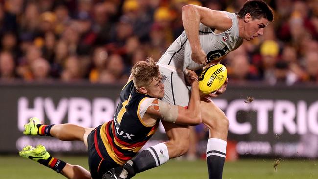 Crow Hugh Greenwood tackles Carlton’s Matthew Kreuzer during the match at Adelaide Oval. Picture: James Elsby / AFL Media / Getty