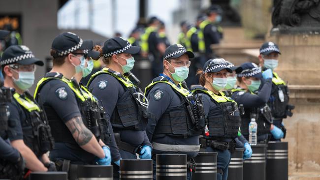 Police line up Parliament House in Melbourne. Picture: Tony Gough