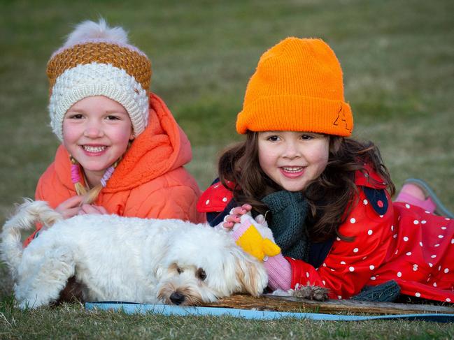 Beating the cold weather with beanies at Bondi are five-year-olds Claudia Jezewski (left) with friend Indi Martin and their friend’s dog Munchie.
