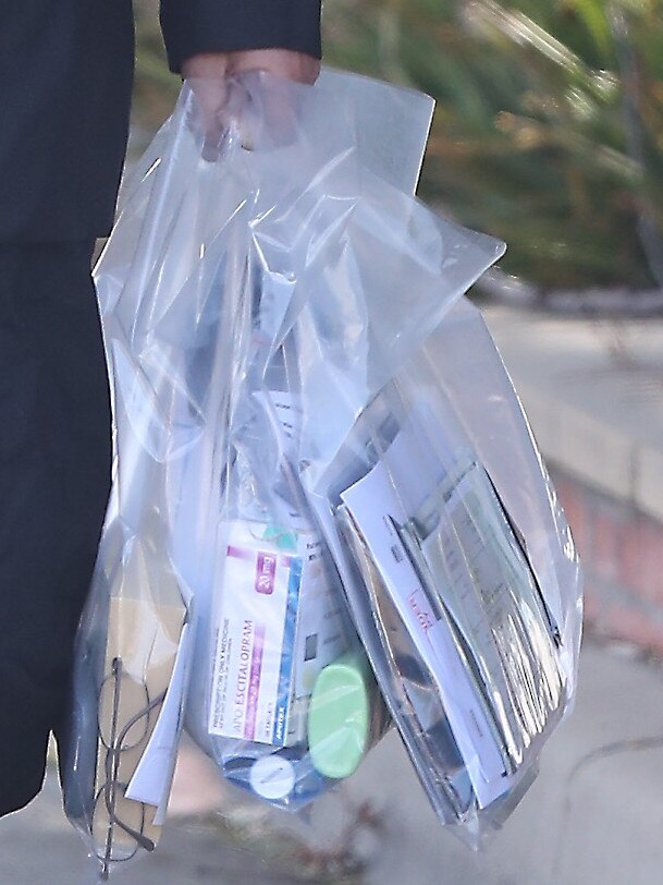 The convicted sex offender left prison carrying bags of documents and medication.