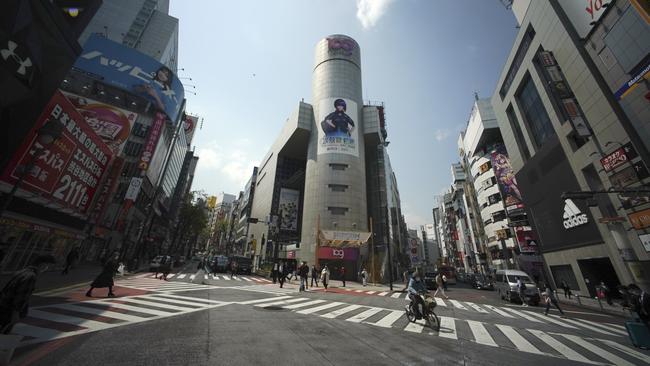 Tokyo’s famous Shibuya Scramble Crossing is usually chaotic but is much quieter as Japan’s state of emergency clampdowns begin. Picture: AP