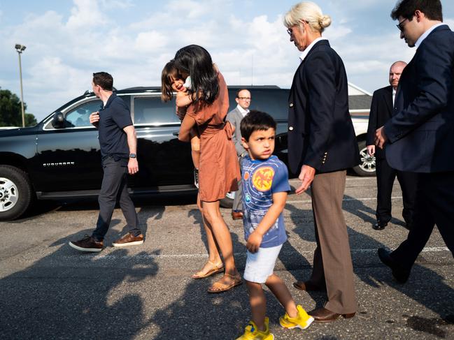 Usha Vance, wife of Republican vice presidential nominee JD Vance carries her daughter Maribel Vance and walks with her son Vivek Vance after stopping for a meet and greet with supporters at the Park Diner. Picture: AFP