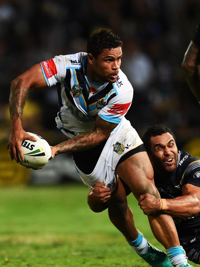 Titan Josh Hoffman is tackled by Cowboys Justin O'Neill. Picture: Zak Simmonds