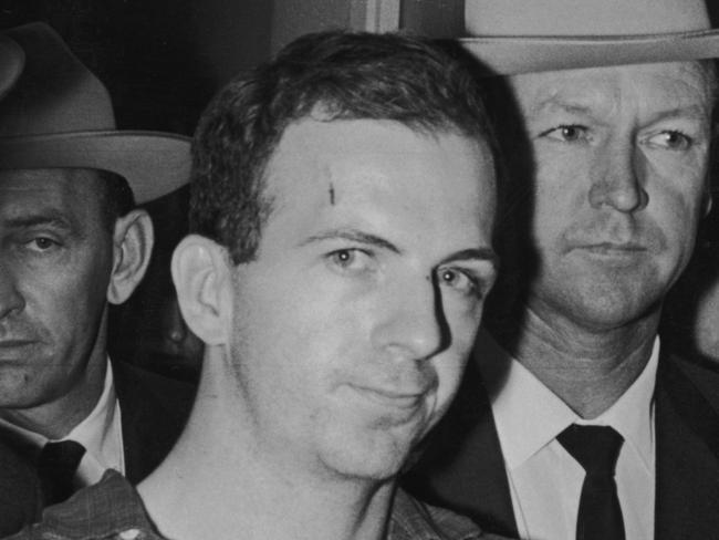 Lee Harvey Oswald (1939 - 1963) (C) is taken into custody by police after allegedly shooting President John F Kennedy, Dallas, Texas.  (Photo by Archive Photos/Getty Images)