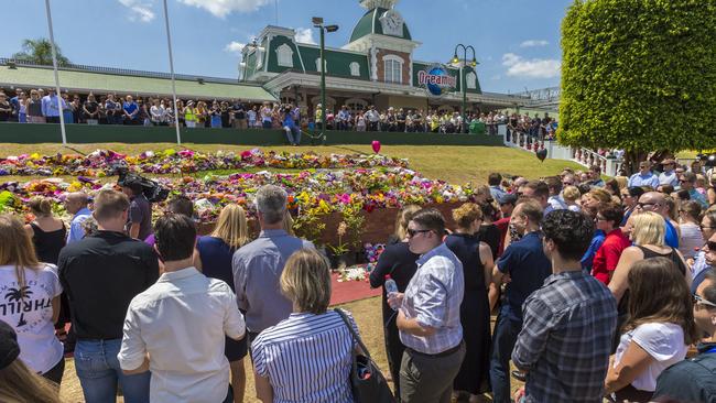 Staff members gather after a private memorial was held at Dreamworld in 2016. Picture: Glenn Hunt