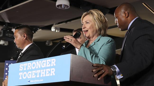 Secret Service agents surround Democratic presidential candidate Hillary Clinton on stage after animal activists disrupted her campaign in Las Vegas on Thursday. Picture: AP