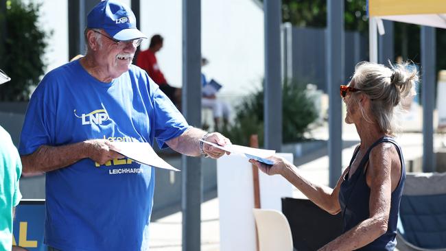 Retiring Member for Leichhardt Warren Entsch hands out how to vote cards for the federal election at the Australian Electoral Commission pre polling centre, set up at the former Tjapukai Cultural Park in Smithfield, Cairns. Picture: Brendan Radke