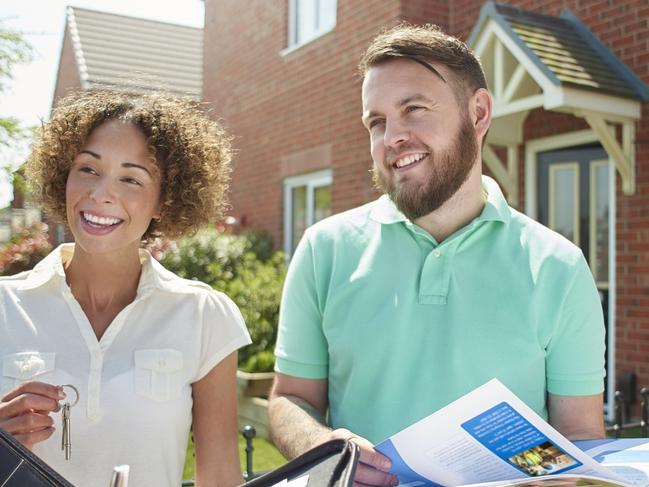 Leader Hot Topic photo - 2017 investment tips - iStock - buying house - investment property - iStock-532574266 - a mid adult couple  receive the keys to their new house from the estate agent  . They are standing in their garden in front of a semi detached house holding the keys and shaking hands .