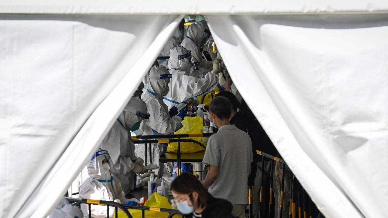 Health workers conduct Covid-19 coronavirus testing at a makeshift testing site in Zhongguancun in Beijing. Picture: AFP.