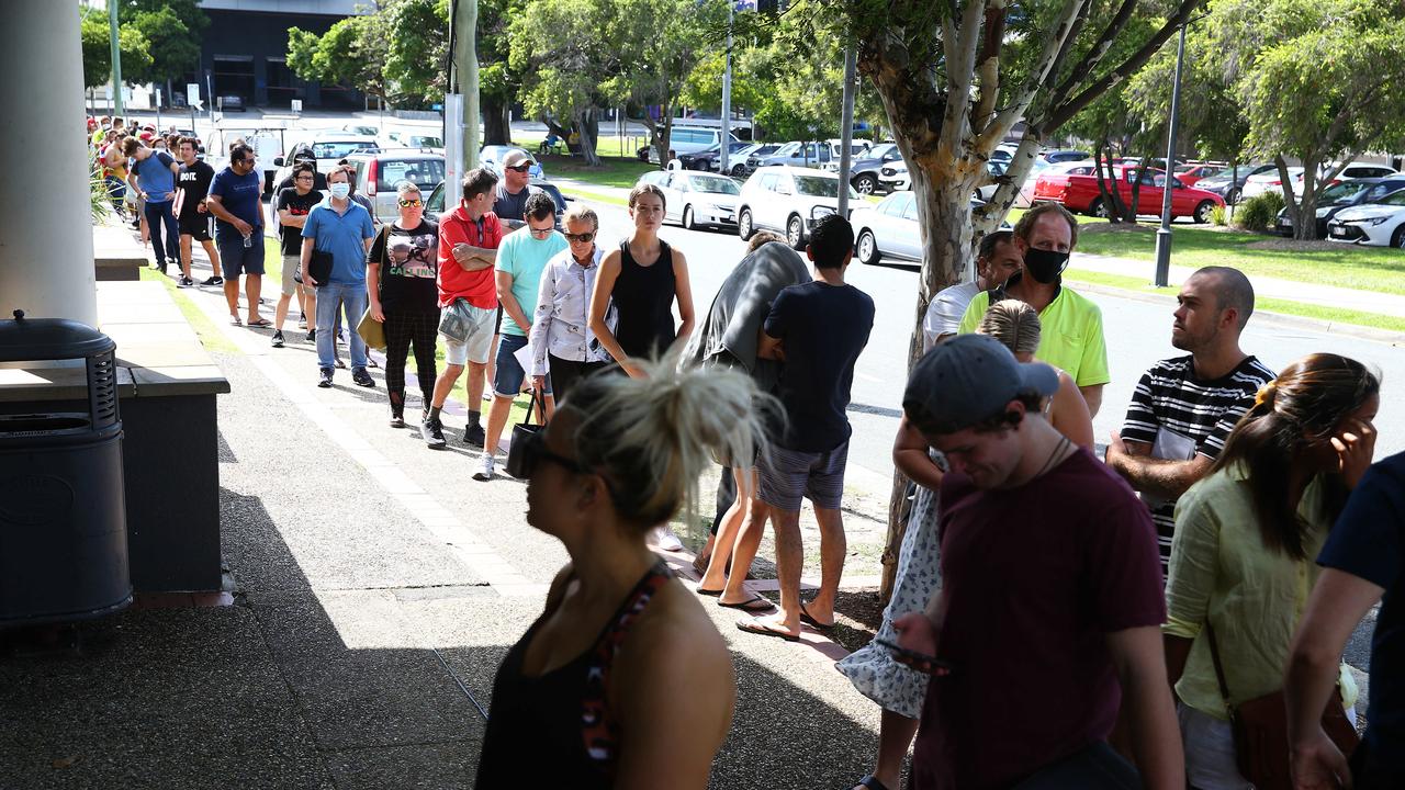 Lines of people wait at Southport Centrelink. Picture: Adam Head.