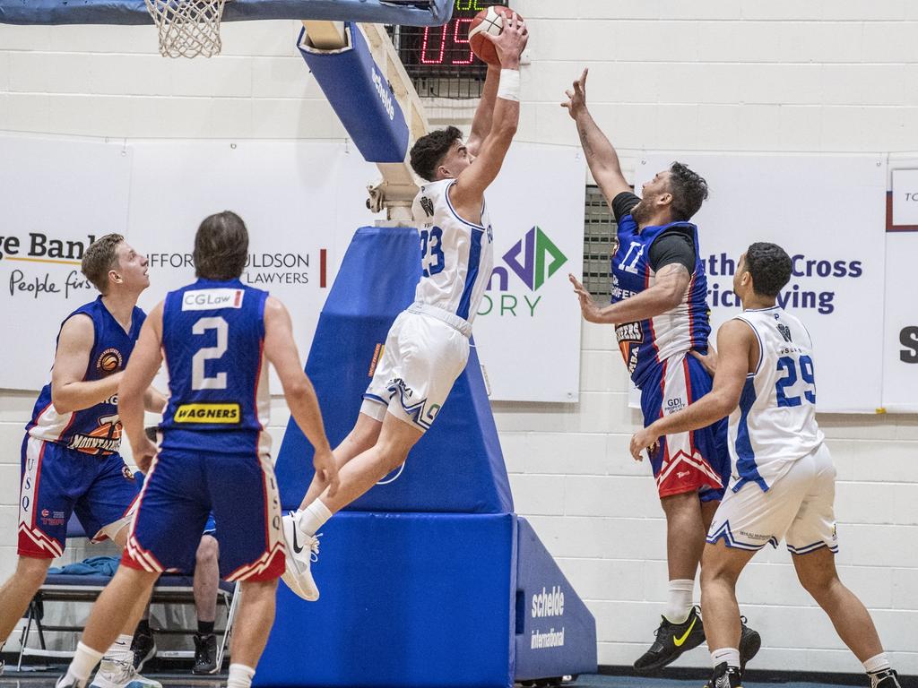 Ben Tweedy soars high to block a shot in action for the Gold Coast Rollers in the NBL1 North. Picture: Nev Madsen.